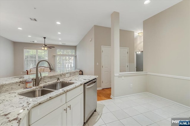 kitchen featuring a sink, stainless steel dishwasher, a ceiling fan, recessed lighting, and white cabinets