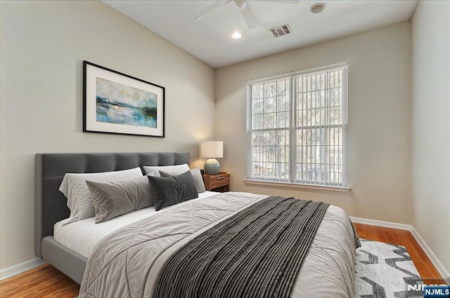 bedroom featuring baseboards, wood finished floors, recessed lighting, and ceiling fan