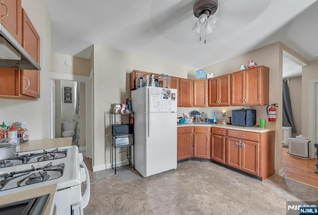 10 Orchard St, Elmwood Park, NJ 07407 - kitchen featuring white appliances, under cabinet range hood, ceiling fan, light countertops, and brown cabinetry