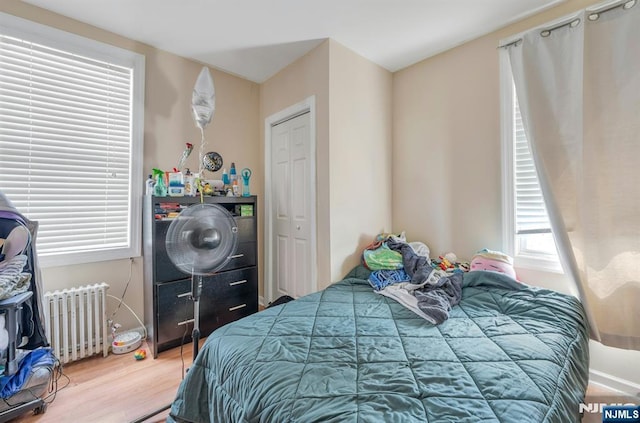 10 Orchard St, Elmwood Park, NJ 07407 - bedroom with radiator, wood finished floors, and a closet