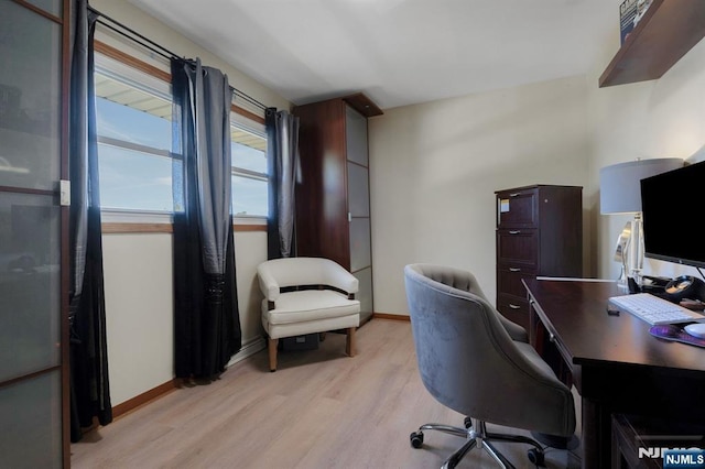 office space with light wood-style floors and baseboards