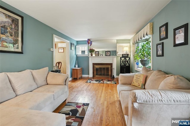 living area with light wood-style floors and a fireplace