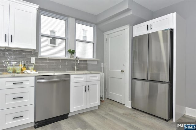 228 Ridgefield Ave, Bogota, NJ 07603 - kitchen with appliances with stainless steel finishes, a sink, light countertops, and white cabinets