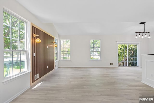 52 Straton Ct Unit 1006, Sayreville, NJ 08859 - unfurnished living room with healthy amount of natural light, light wood-style flooring, lofted ceiling, and baseboards
