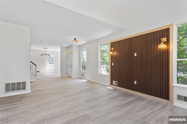 52 Straton Ct Unit 1006, Sayreville, NJ 08859 - unfurnished living room with stairs, light wood-style floors, and healthy amount of natural light