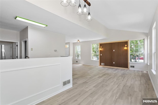 52 Straton Ct Unit 1006, Sayreville, NJ 08859 - unfurnished living room with lofted ceiling, light wood-style flooring, baseboards, and a chandelier
