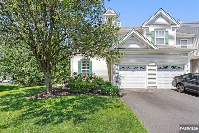 52 Straton Ct Unit 1006, Sayreville, NJ 08859 - view of front of home with asphalt driveway, a front lawn, and an attached garage
