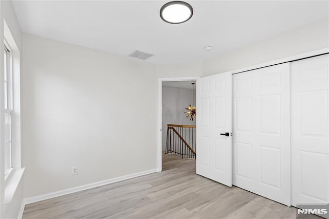 52 Straton Ct Unit 1006, Sayreville, NJ 08859 - unfurnished bedroom with light wood-style flooring, a closet, and baseboards