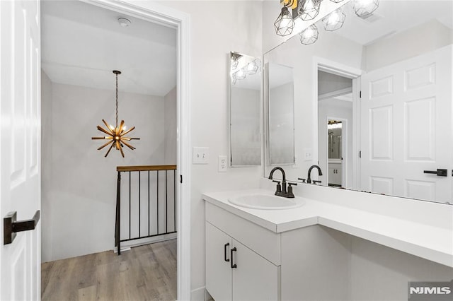 52 Straton Ct Unit 1006, Sayreville, NJ 08859 - bathroom featuring a chandelier, wood finished floors, and vanity