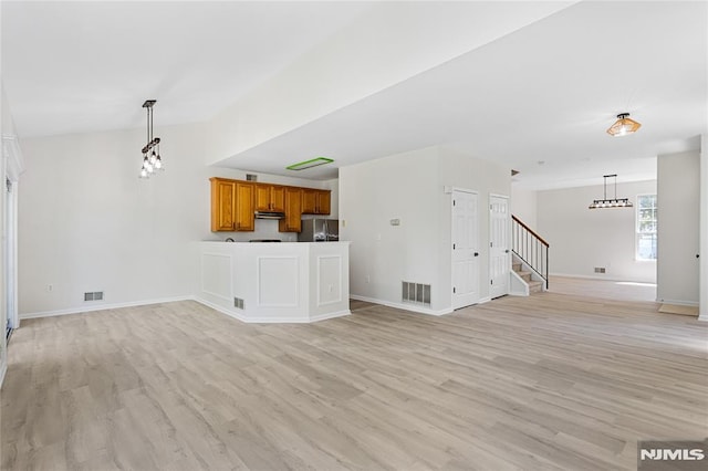 52 Straton Ct Unit 1006, Sayreville, NJ 08859 - unfurnished living room featuring light wood-style flooring, stairs, baseboards, and a chandelier