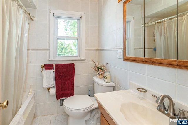 bathroom featuring tile walls, toilet, tile patterned flooring, vanity, and shower / bathtub combination with curtain
