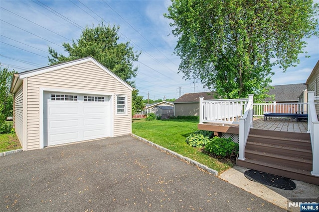 detached garage with asphalt driveway