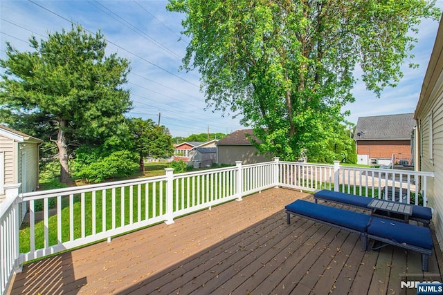 wooden terrace with a lawn