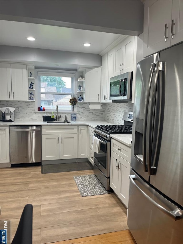 60 Palisades, Bergenfield, NJ 07621 - kitchen with appliances with stainless steel finishes, open shelves, a sink, white cabinets, and light countertops
