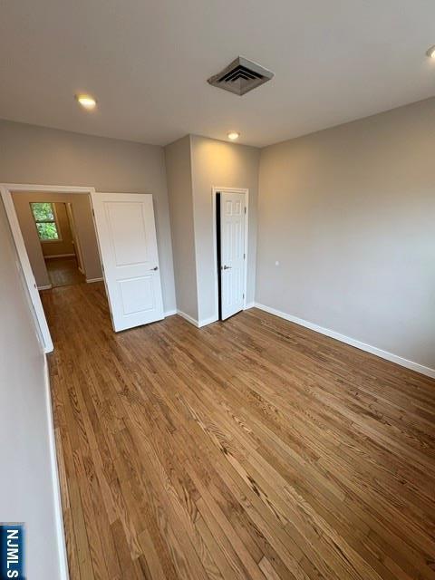 150 W 29th, Bayonne, NJ 07002 - unfurnished bedroom featuring wood finished floors, baseboards, recessed lighting, and a closet