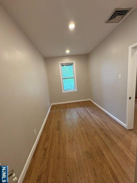 150 W 29th, Bayonne, NJ 07002 - unfurnished room featuring baseboards, wood finished floors, and recessed lighting