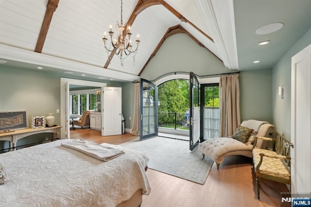 bedroom with access to outside, high vaulted ceiling, wood finished floors, and a chandelier