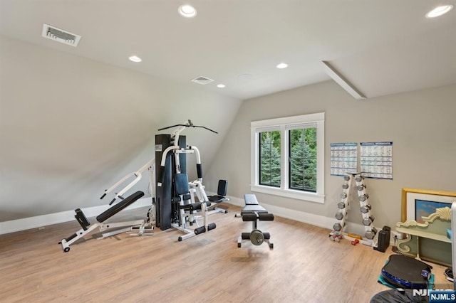 workout area featuring wood finished floors, baseboards, recessed lighting, and vaulted ceiling