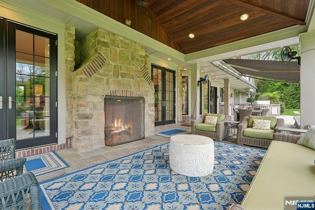 view of patio featuring an outdoor living space with a fireplace and area for grilling