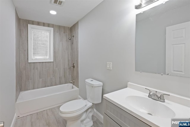 full bath with baseboards, toilet, vanity, and shower / bath combination