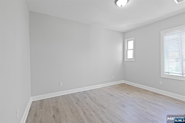 empty room with wood finished floors and baseboards