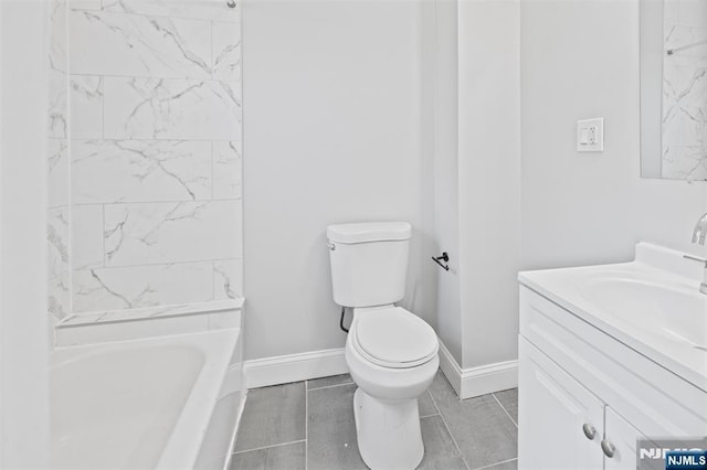 full bath with toilet, vanity, and baseboards