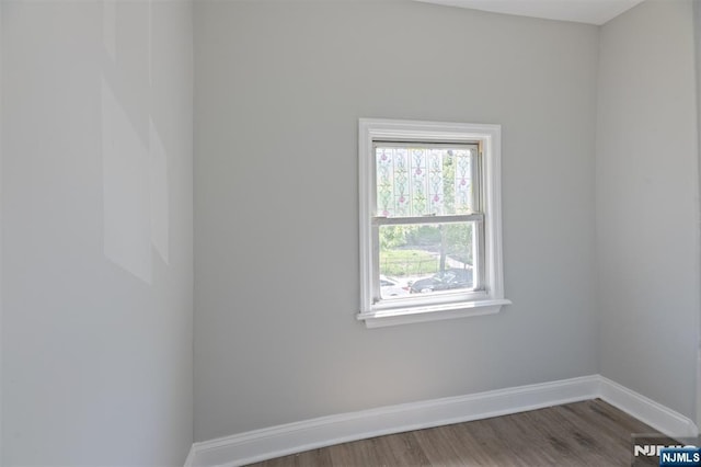 empty room featuring baseboards and wood finished floors