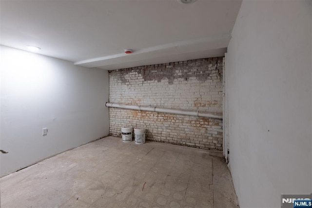 below grade area featuring brick wall
