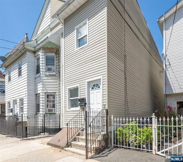 view of property with fence, entry steps, and cooling unit
