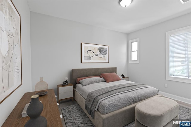 bedroom featuring wood finished floors and baseboards