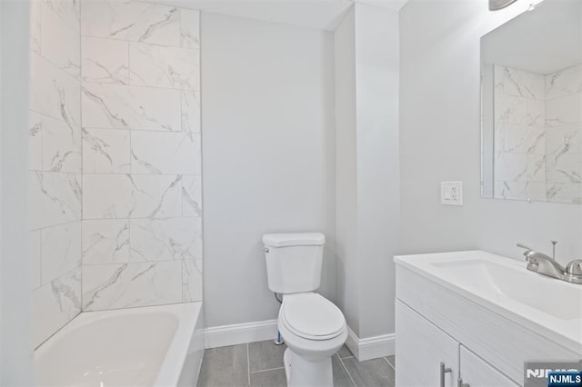 full bathroom with toilet, vanity, baseboards, and  shower combination