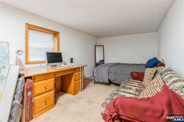 bedroom featuring light carpet, a desk, and crown molding