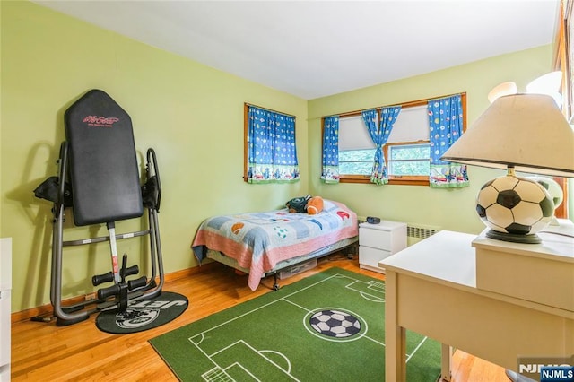 bedroom with wood finished floors and baseboards