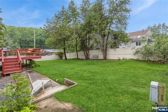 view of yard with a wooden deck