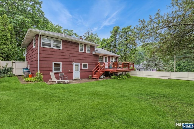 rear view of house with a wooden deck