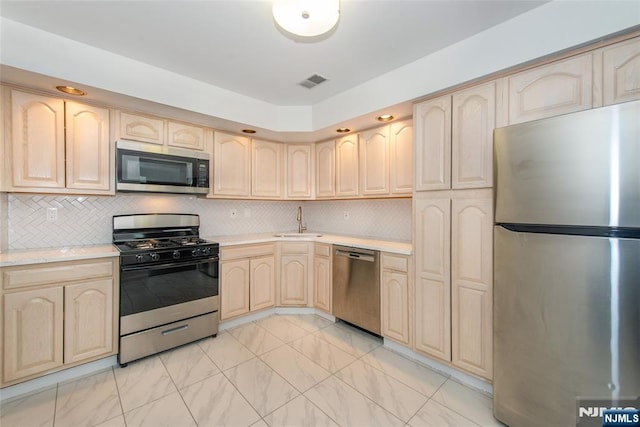 37 Krueger Ct, Newark, NJ 07103 - kitchen with appliances with stainless steel finishes, light brown cabinets, a sink, light marble finish flooring, and tasteful backsplash
