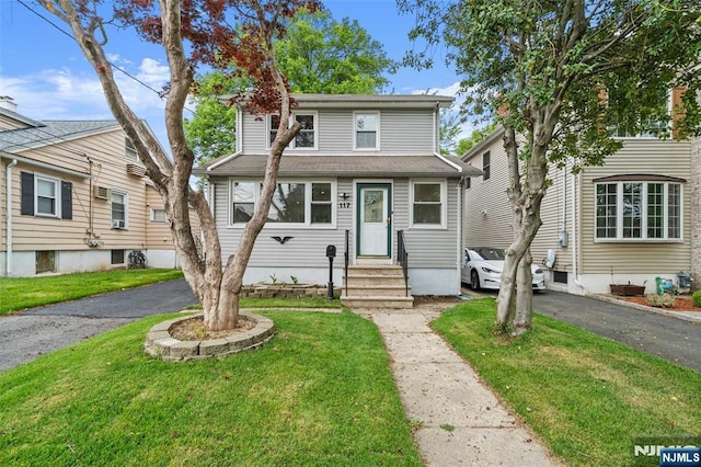 traditional style home with entry steps and a front yard