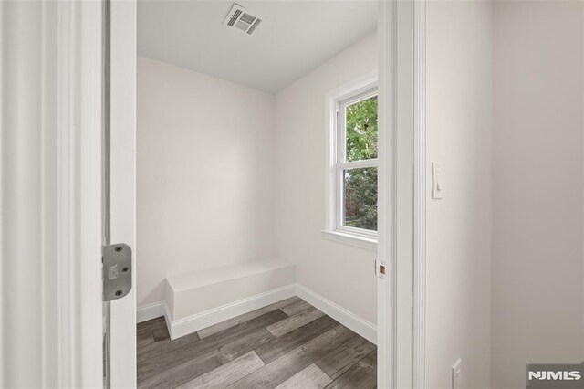 washroom featuring wood finished floors and baseboards