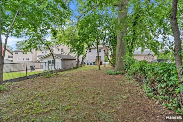 view of yard featuring fence and a residential view