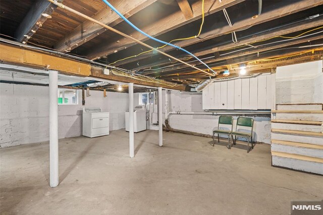 below grade area featuring separate washer and dryer and stairs