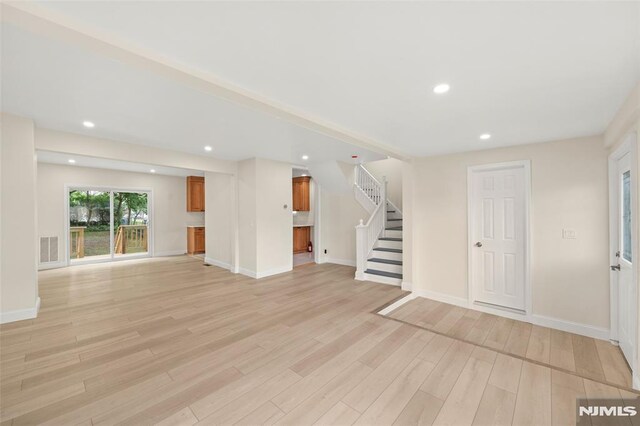 unfurnished living room with light wood-type flooring, stairs, baseboards, and recessed lighting