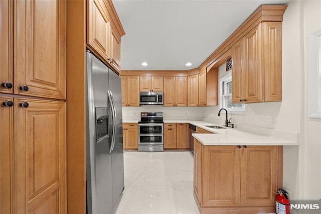 kitchen with stainless steel appliances, light marble finish floors, a sink, a peninsula, and recessed lighting