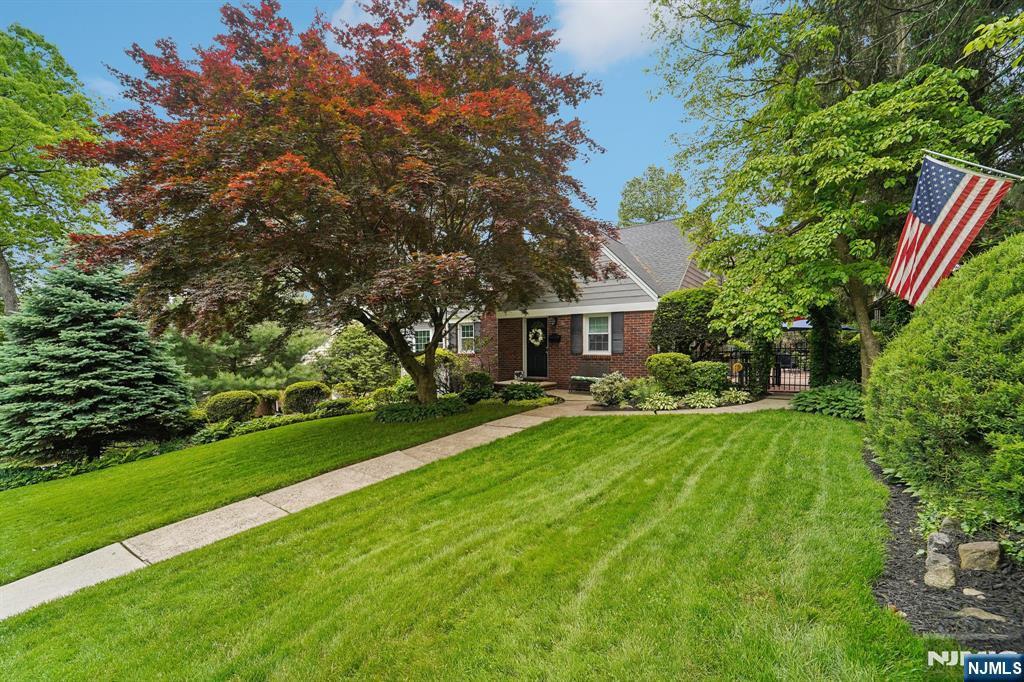 70 Lexington Ave, Cresskill, NJ 07626 - obstructed view of property featuring a front yard, brick siding, and a gate