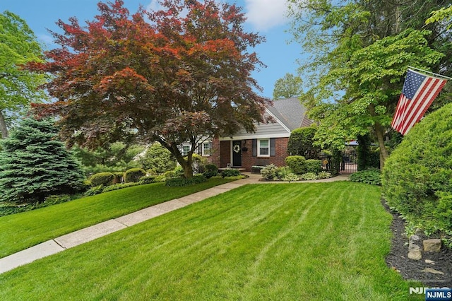 70 Lexington Ave, Cresskill, NJ 07626 - obstructed view of property featuring a front yard, brick siding, and a gate