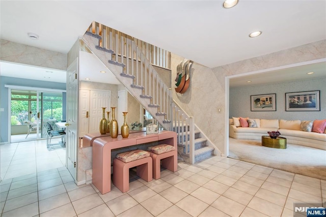 staircase with wallpapered walls, tile patterned flooring, and recessed lighting