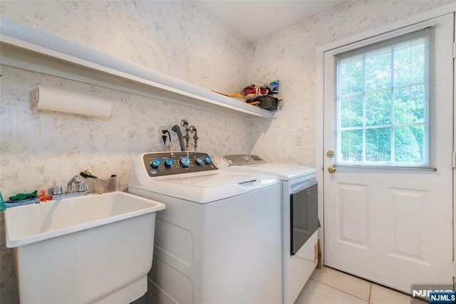 laundry room with plenty of natural light, washer and dryer, light tile patterned floors, and wallpapered walls