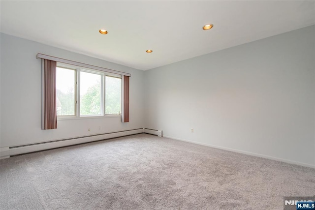 carpeted spare room featuring baseboard heating, recessed lighting, and baseboards