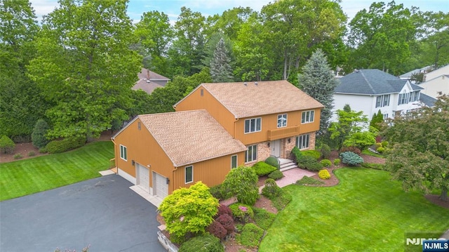 aerial view of property and surrounding area with a tree filled landscape