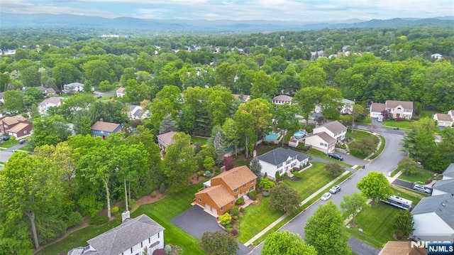 aerial view of residential area featuring a forest