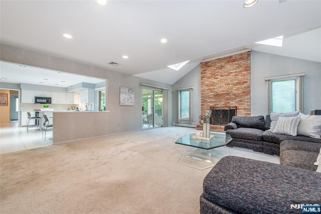 living area with plenty of natural light, vaulted ceiling, recessed lighting, a skylight, and light carpet